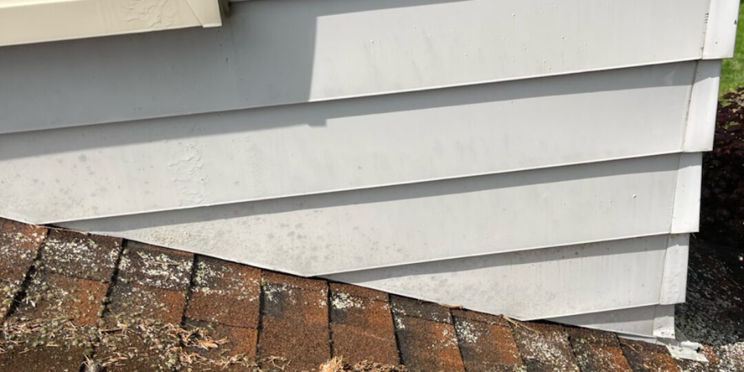 Siding at the roofline after power washing